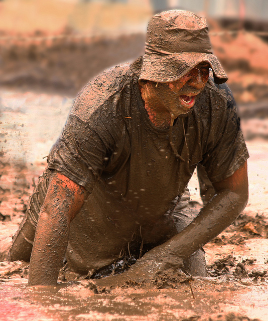 Man walking through mud